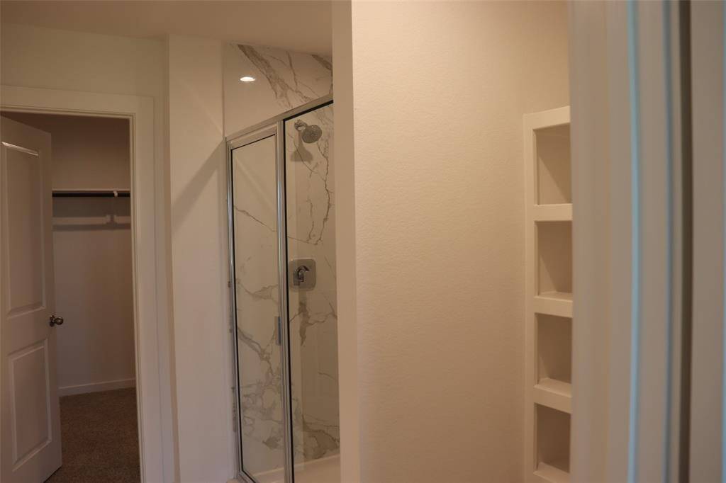 Oversized primary bath with double sinks, shower and storage
