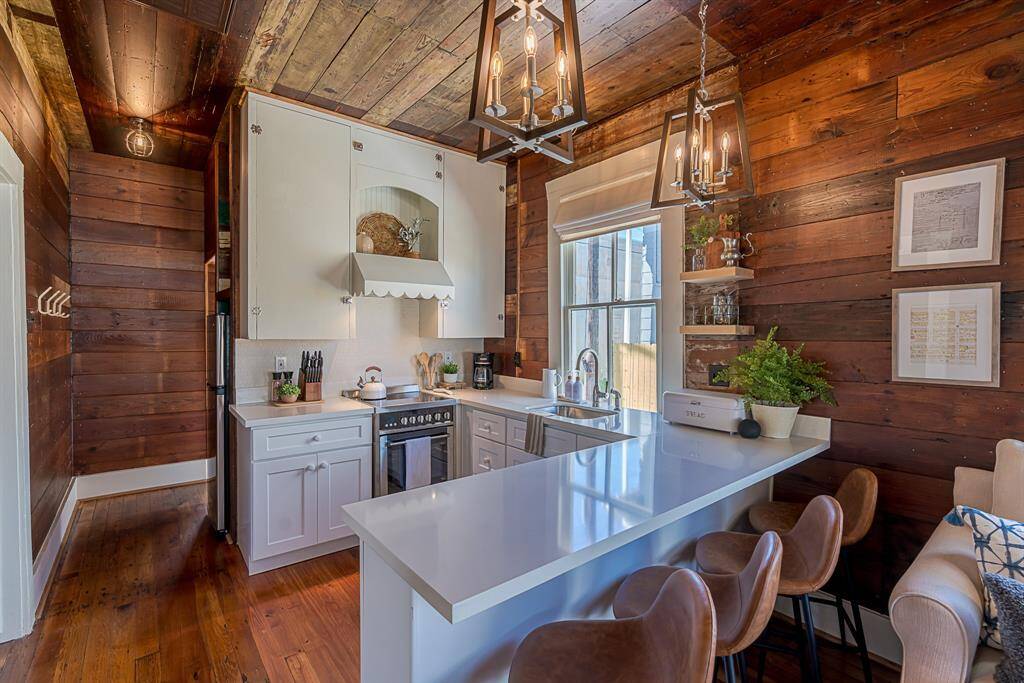 Back House: Chef's kitchen features quartz countertops, stainless steel appliances and a breakfast bar