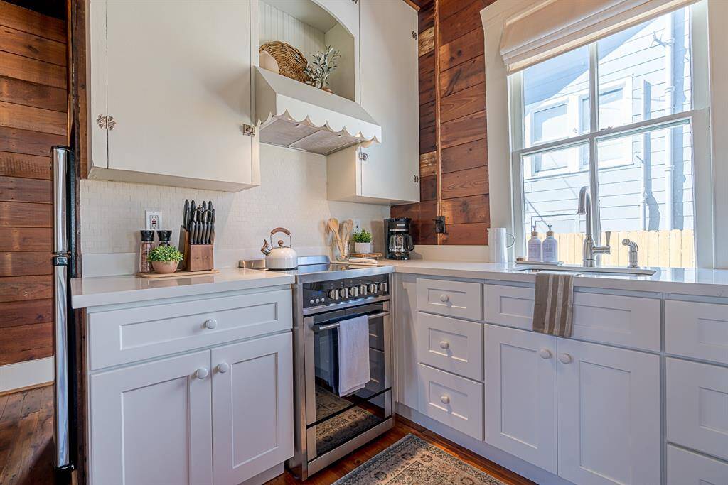 Back House: Chef's kitchen features quartz countertops, stainless steel appliances and a breakfast bar