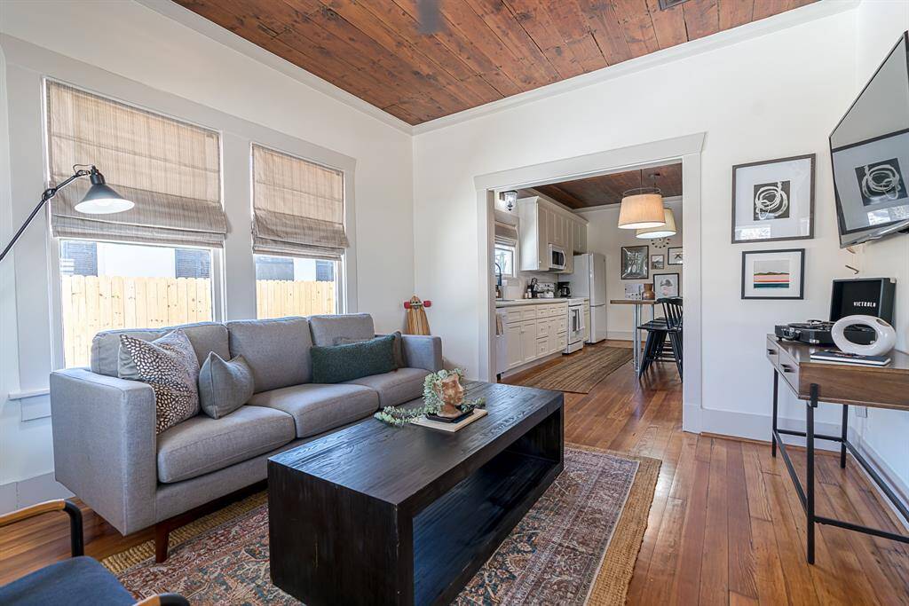 Front House: Enter from a covered front porch to a living room and original refinished wood flooring throughout