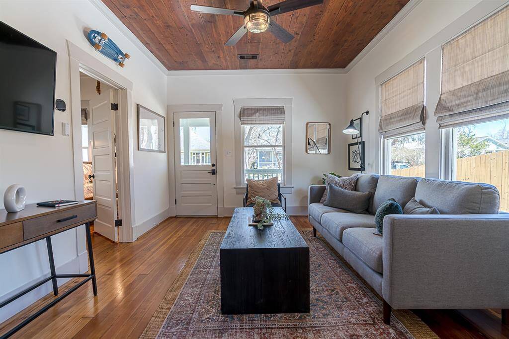 Front House: Enter from a covered front porch to a living room and original refinished wood flooring throughout