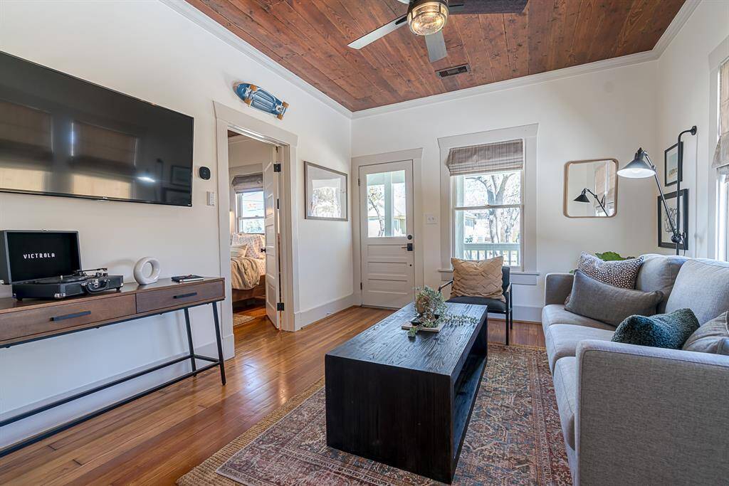 Front House: Enter from a covered front porch to a living room and original refinished wood flooring throughout