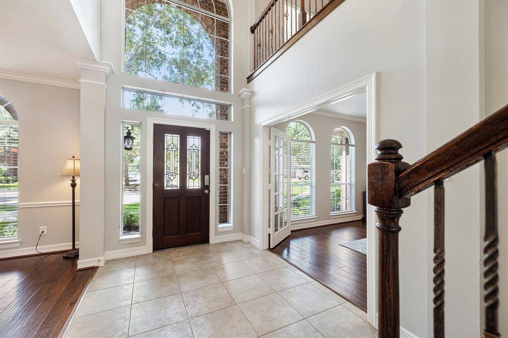 Walking into the home, the two-story entry invites positive attention and welcomes guests in a most impressive fashion. Deep, richly toned wood and wrought iron help create a visually pleasing, staircase, highlighting the appreciation for rounded edges and dapper details.