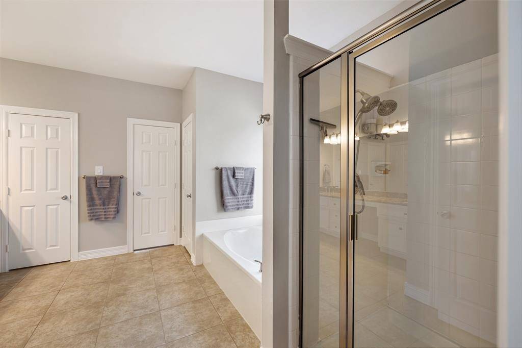 Come home to a glass of wine and a hot aromatherapy bubble bath in your enormous soaking tub. Afterward, easily rinse off the extra bubbles in the separate and glass enclosed shower.
