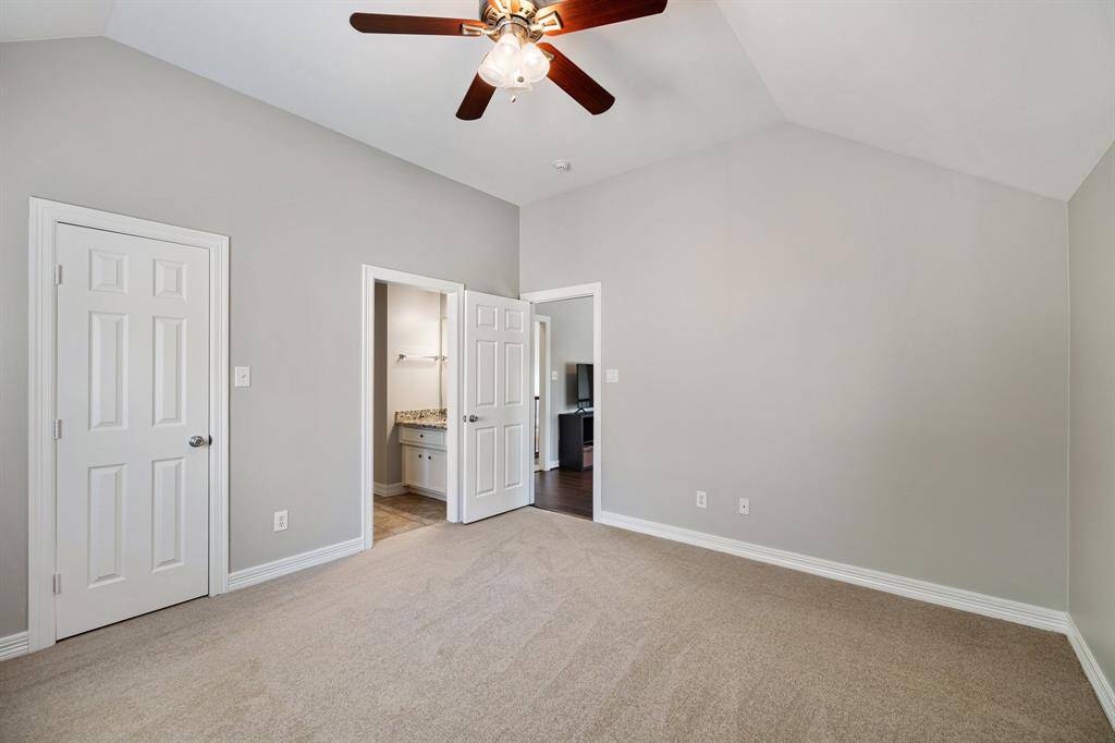 White baseboards frame and architecturally interesting roof angles give depth. Neutral tones and plush carpet create an ideal bedroom for guests, babies, or children.