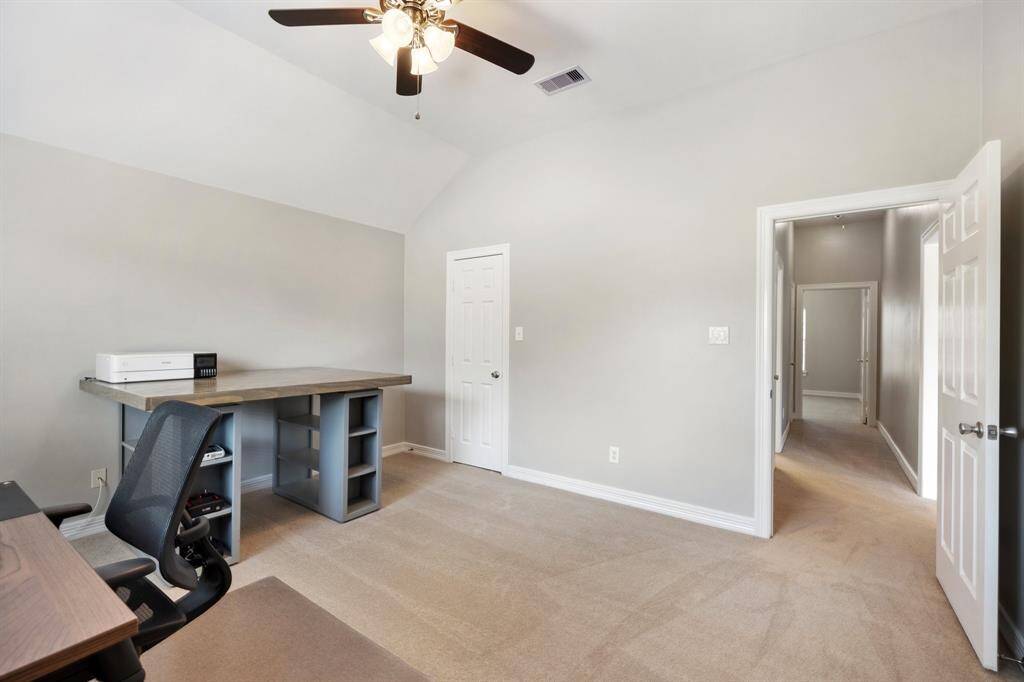 High ceilings with interesting angles provide a unique quality, while the neutral carpet contributes a fantastic backdrop for a variety of style preferences. Featuring a large window and a ceiling fan, the bedroom may also be ideal as a telecommuting office.