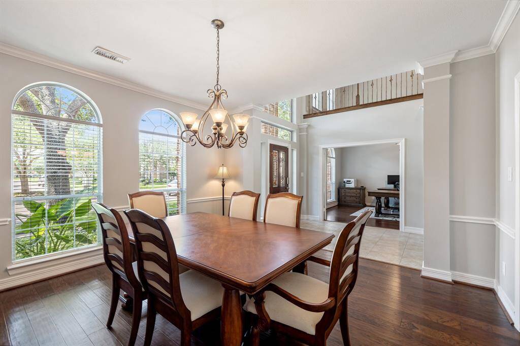 High-ceilings and hardwood floors create a formal feeling, yet the large windows soften the appearance for a formal dining area.