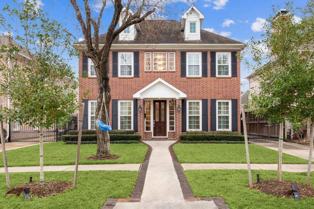 Stunning West U home featuring classic architecture and beautifully landscaped.