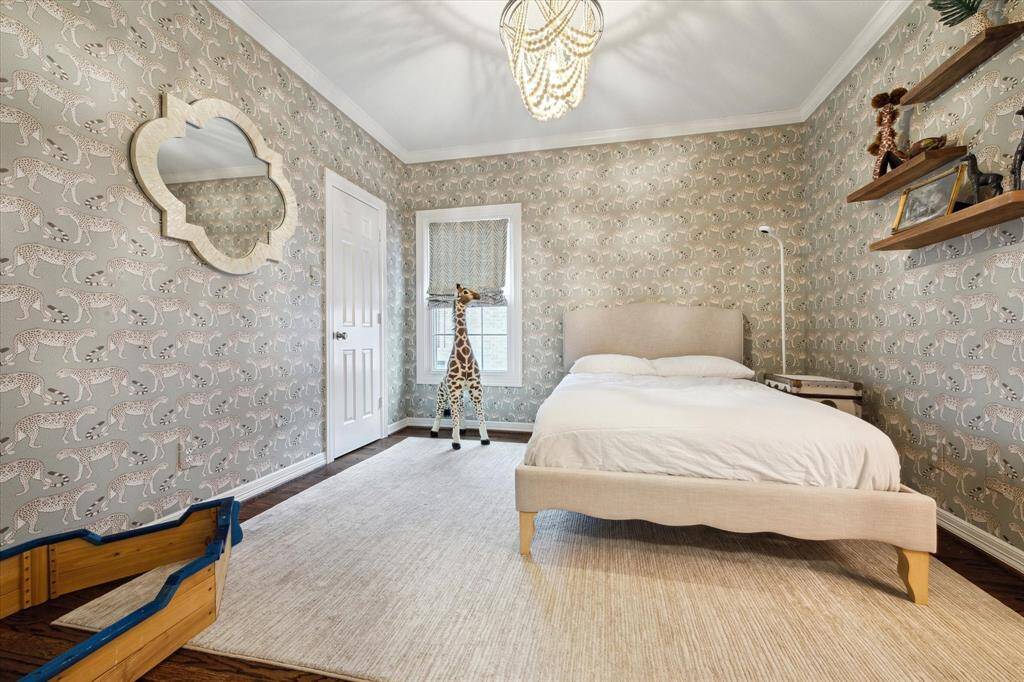 "Featuring Cole & Son wallpaper, this spacious secondary bedroom offers ample closet space for added convenience.