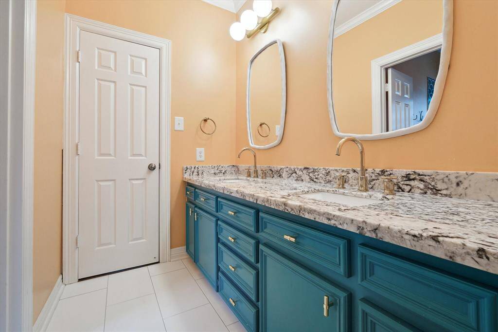 Charming Jack and Jill bathroom connecting two secondary bedrooms, designed for convenience and functionality.