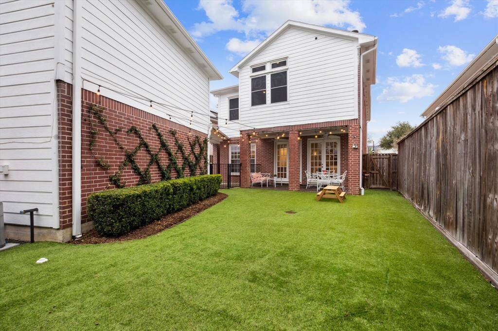 View of the turfed backyard, offering a perfect hangout space with low-maintenance charm.