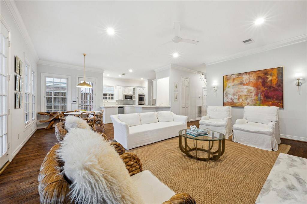 This view of the living space showcases the open floorplan, highlighting the updated kitchen and kitchen nook, as well as a bar perfect for entertaining.