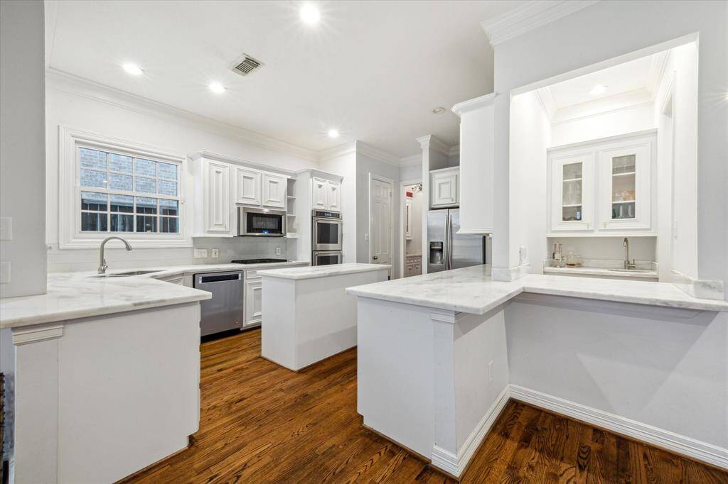 Beautifully updated kitchen designed to keep the cook engaged, as it opens to the living room, creating a seamless flow for interaction.
