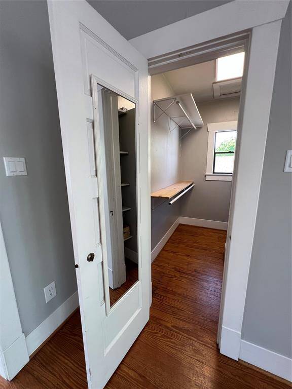 The oversized closet has plenty of storage and a window that lets in natural lighting.