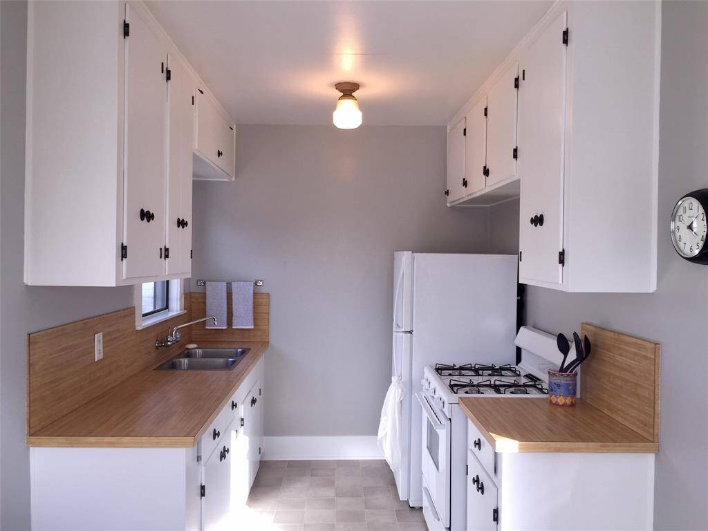 Beautifully updated kitchen has ample storage cabinets and counter space.