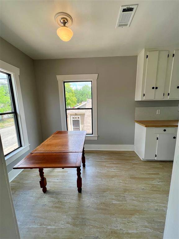 Dining area and kitchen have plenty of natural lighting and updated flooring.