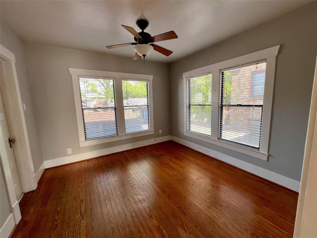 The bedroom features hardwood floors, abundant windows and a large walk in closet.