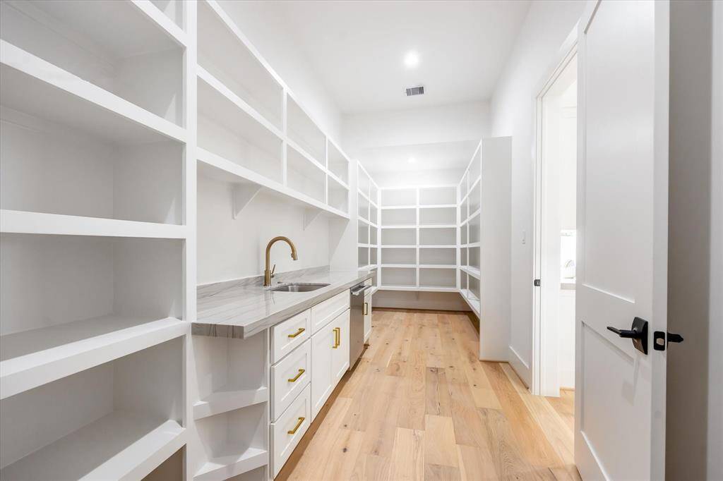 Pantry features additional dishwasher and sink. Room for another fridge in here also!