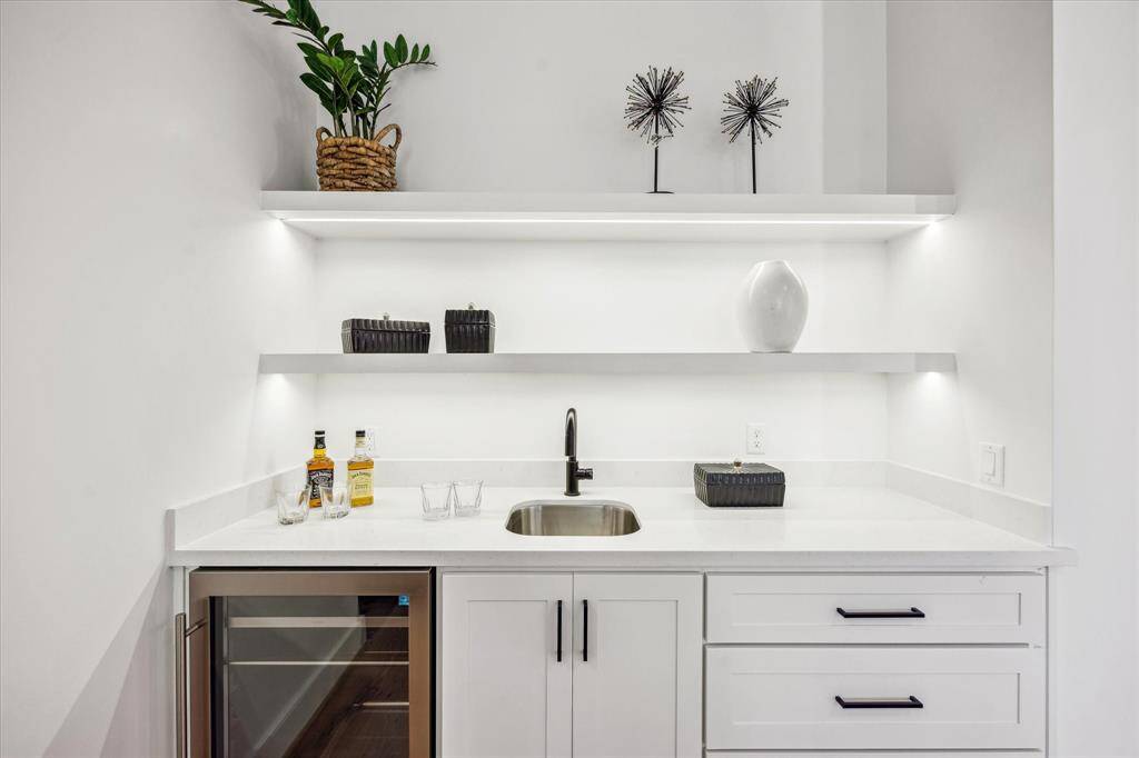 Gameroom with bar sink and beverage center