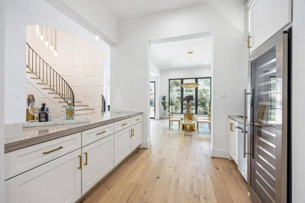 Large butler's pantry with dual temp wine fridge and sink
