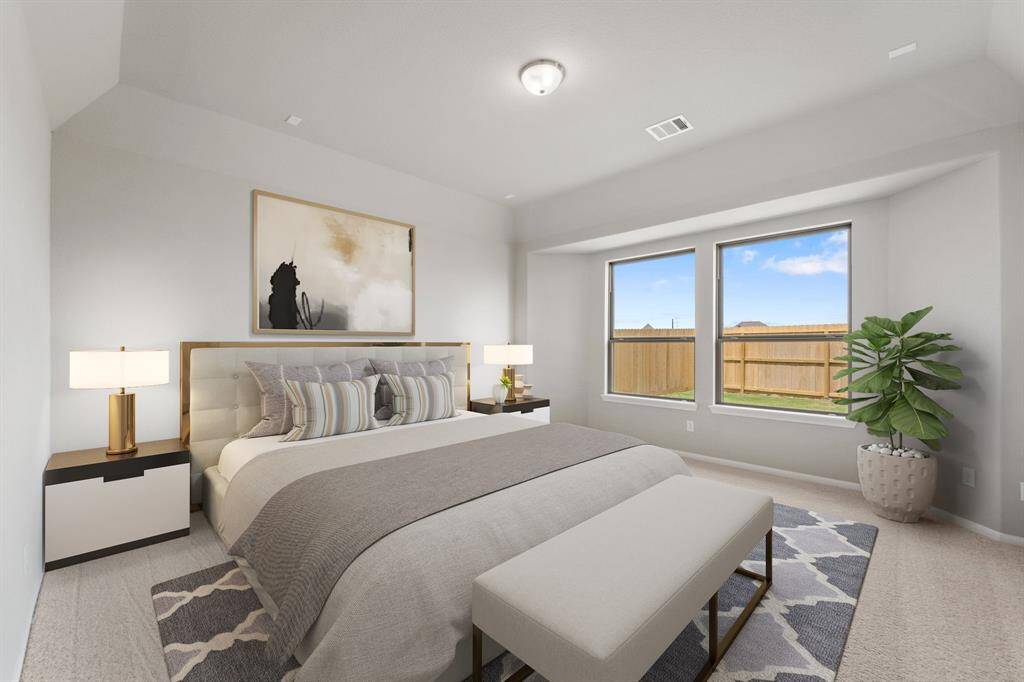 The primary bedroom is generously sized, creating a tranquil and spacious retreat that offers ample room for relaxation. Featuring plush carpet, high ceilings, fresh paint, and large windows that lets in natural lighting throughout the day.