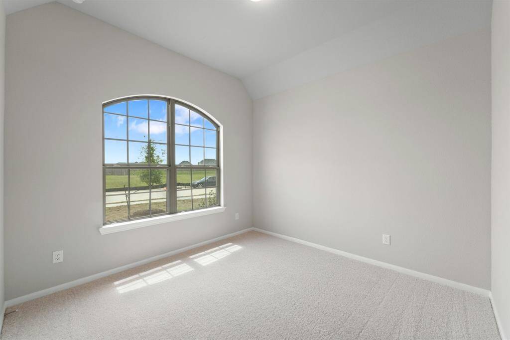 Your secondary bedroom features plush carpet, fresh paint, closet, and a large window that lets in plenty of natural lighting.
