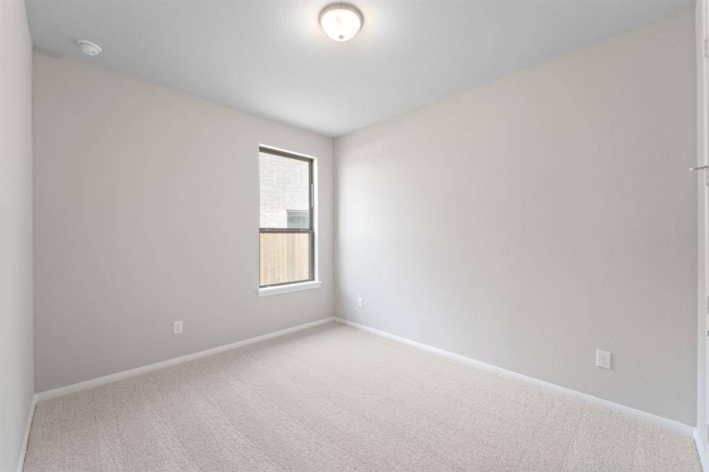 Your secondary bedroom features plush carpet, fresh paint, closet, and a large window that lets in plenty of natural lighting.