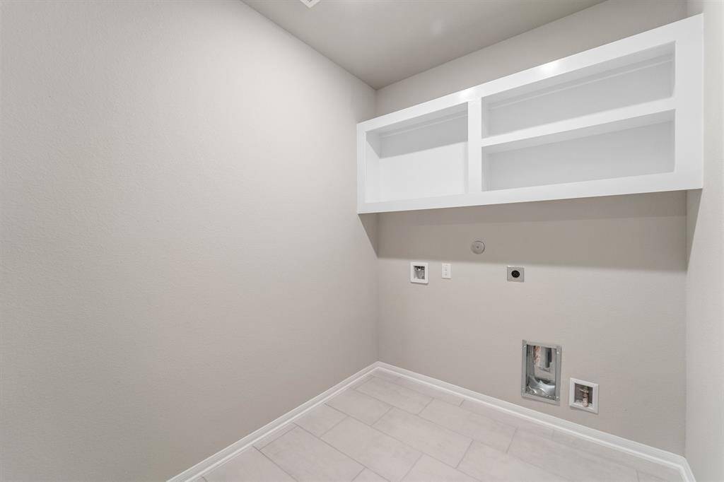 The laundry room layout is carefully planned for optimal workflow with designated areas for washing, drying, and storing.