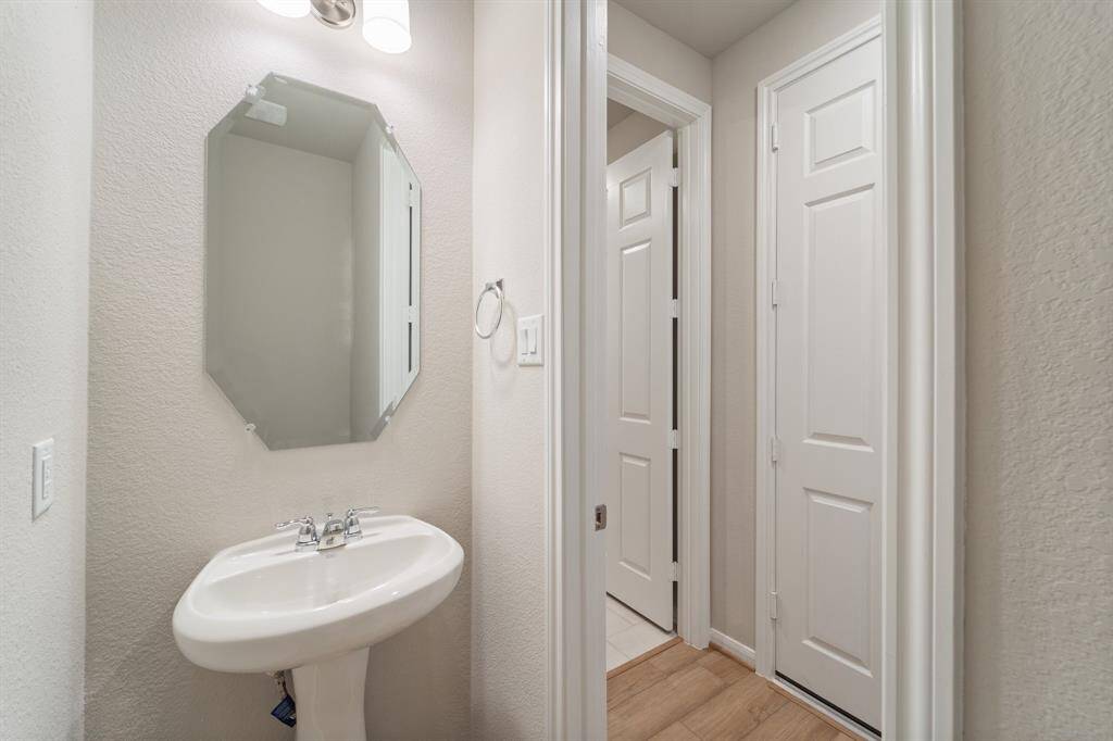 This charming home features a beautifully appointed half bath adjacent to the family room, perfect for welcoming guests and adding convenience to your daily life.