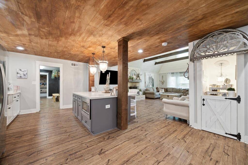 The chef's kitchen features granite countertops, breakfast bar, and ample cabinet space.