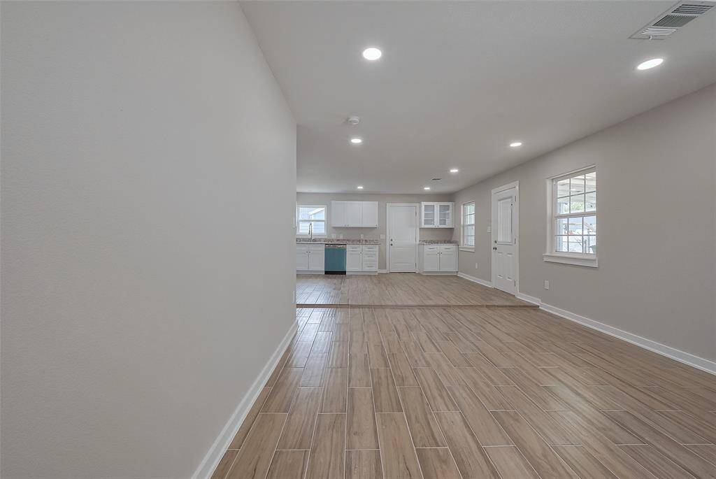 Spacious living room seamlessly connected to the kitchen, perfect for modern living.