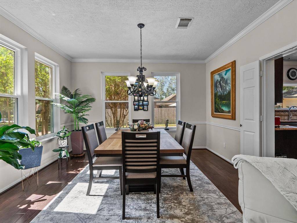 Enjoy family gatherings in your dining area with crown molding, and warm wood floors
