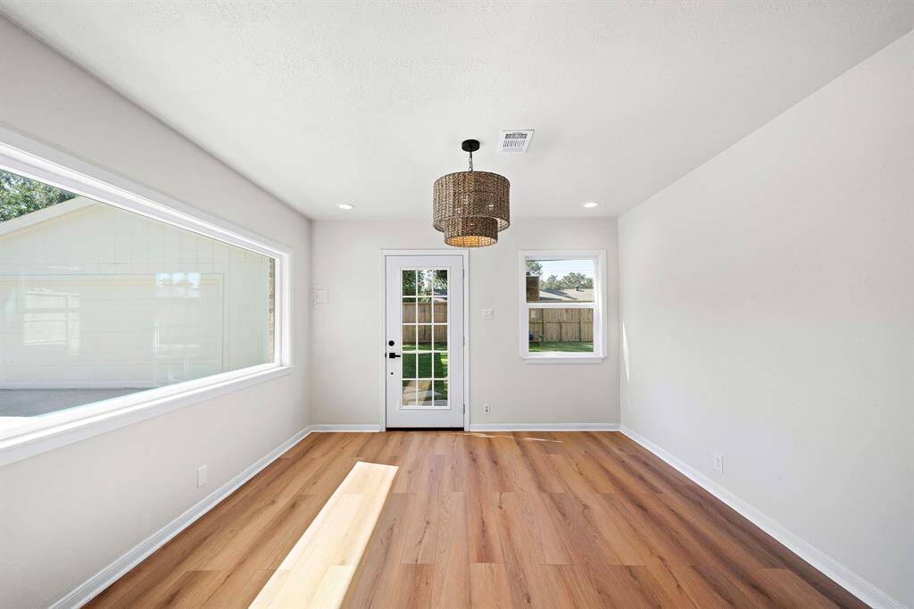 Glass french door leads to backyard and garage.