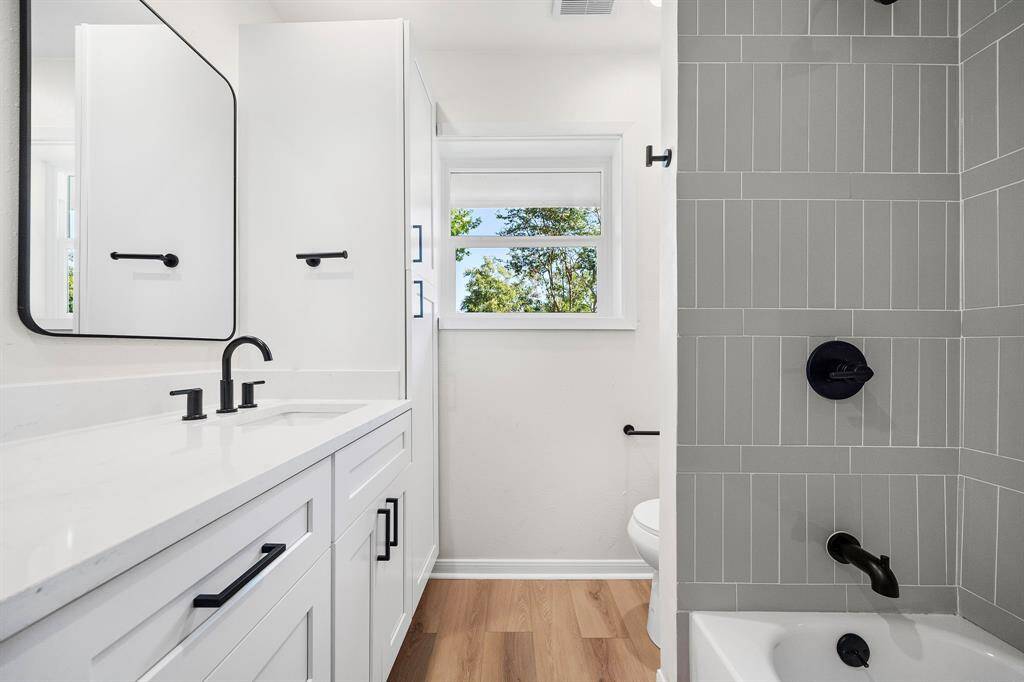 Dual sinks and designer chosen fixtures and finishes in the guest bath.