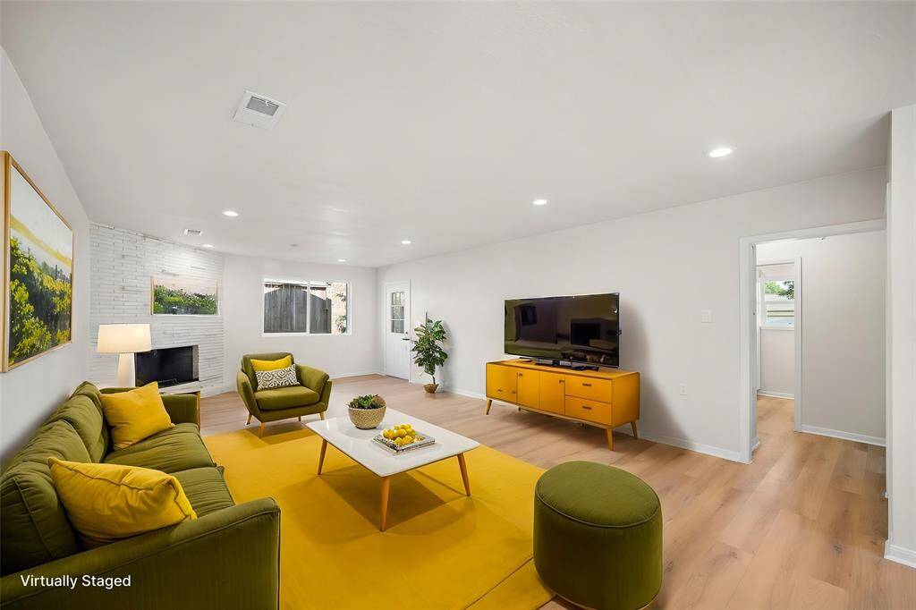 Large picture window next to entrance lets tons of light into the space. Doorway to guest bedrooms and bath on the right. Primary is located on other side of home for additional privacy.