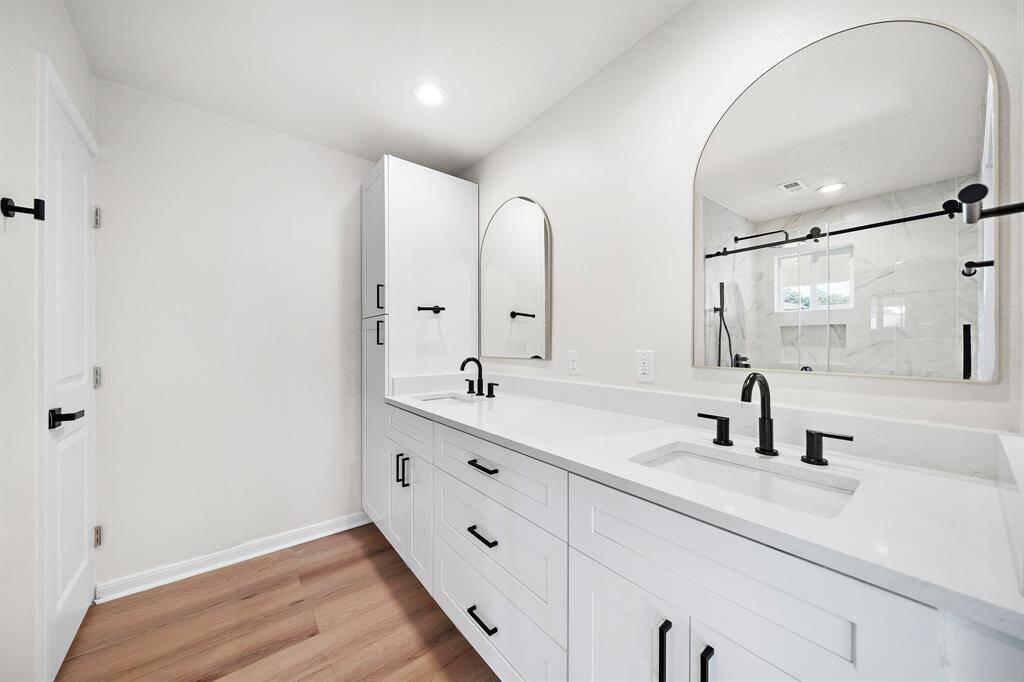 Dual sinks and private water closet in primary bath.