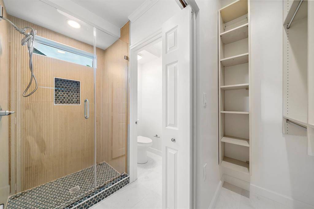 Walk-in shower with two closets adjacent