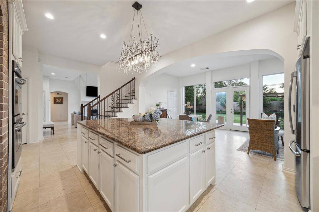 The Primary bedroom is large, has room for a sitting area and overlooks the pool and backyard.
