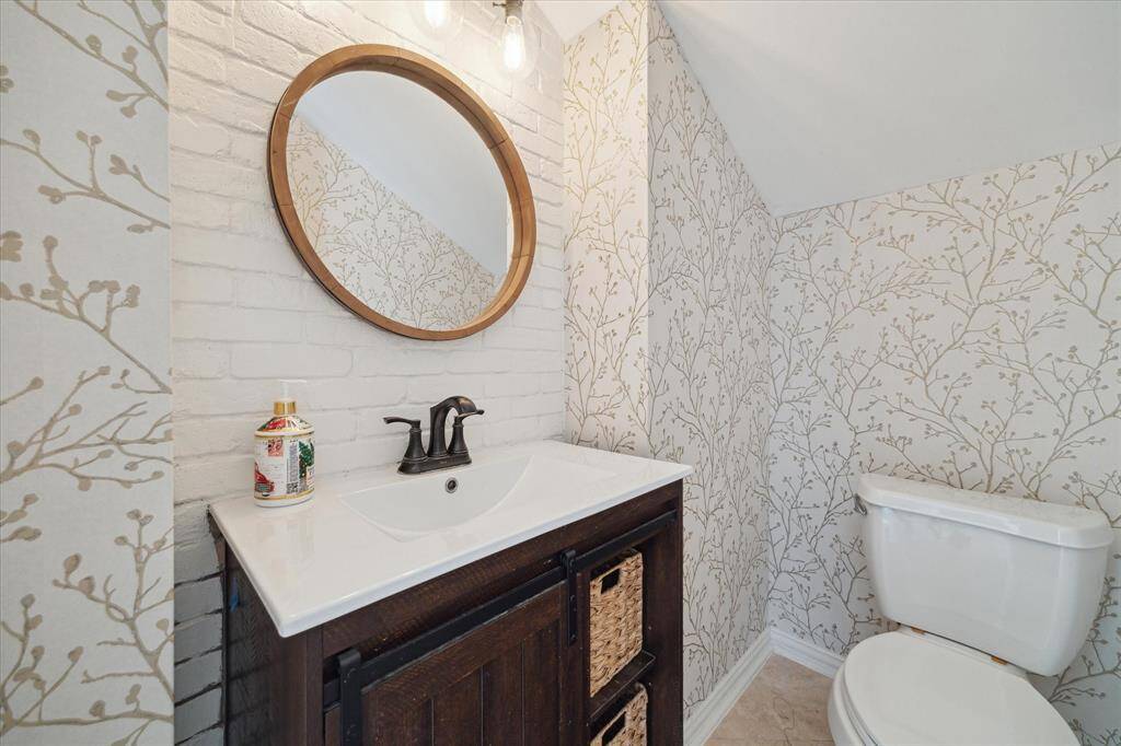 The Primary Bedroom has an ensuite bathroom and a door leading to the backyard.