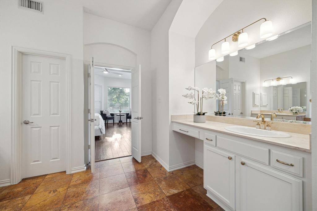 Half Bath is conveniently located across from the primary bedroom and off of the living room, under the stairs.