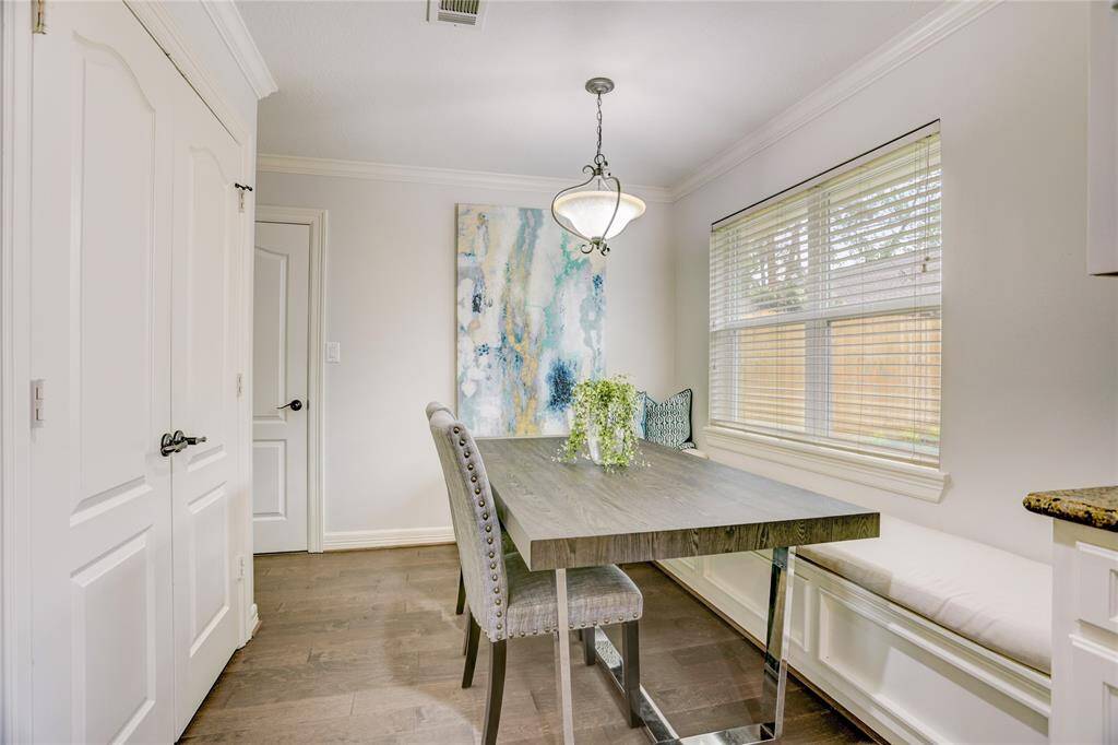 Adjacent to the kitchen sits a breakfast nook with built-in bench seating on two sides. The doors to the left open to a nice pantry.