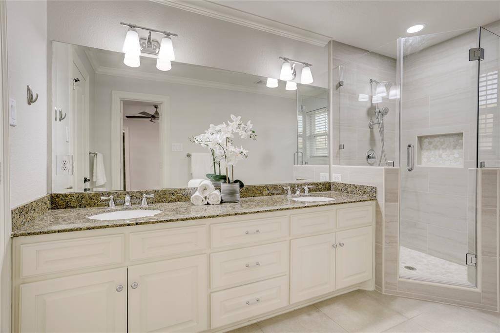 The primary bathroom features dual vanities, a walk-in shower, and closet.