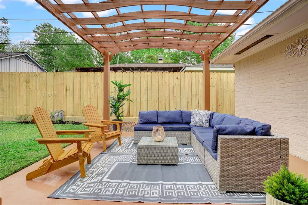 Just outside the sliding doors from the living room is a pergola patio, offering a great opportunity for morning coffee, evening drinks, or bringing the entertaining outside.