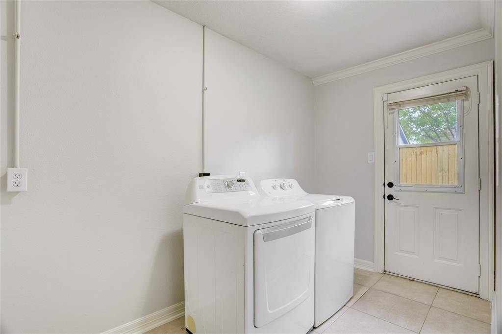 Sitting between the garage and breakfast nook is a spacious utility room with ample space for full-sized units and an additional fridge/freezer or two.
