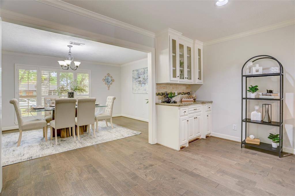 Between the dining room and kitchen sits a built-in dry bar or buffet space.