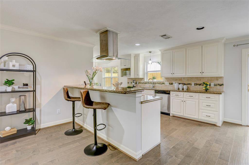 Appreciate and utilize the breakfast bar with open views to the kitchen, living, and dining room.