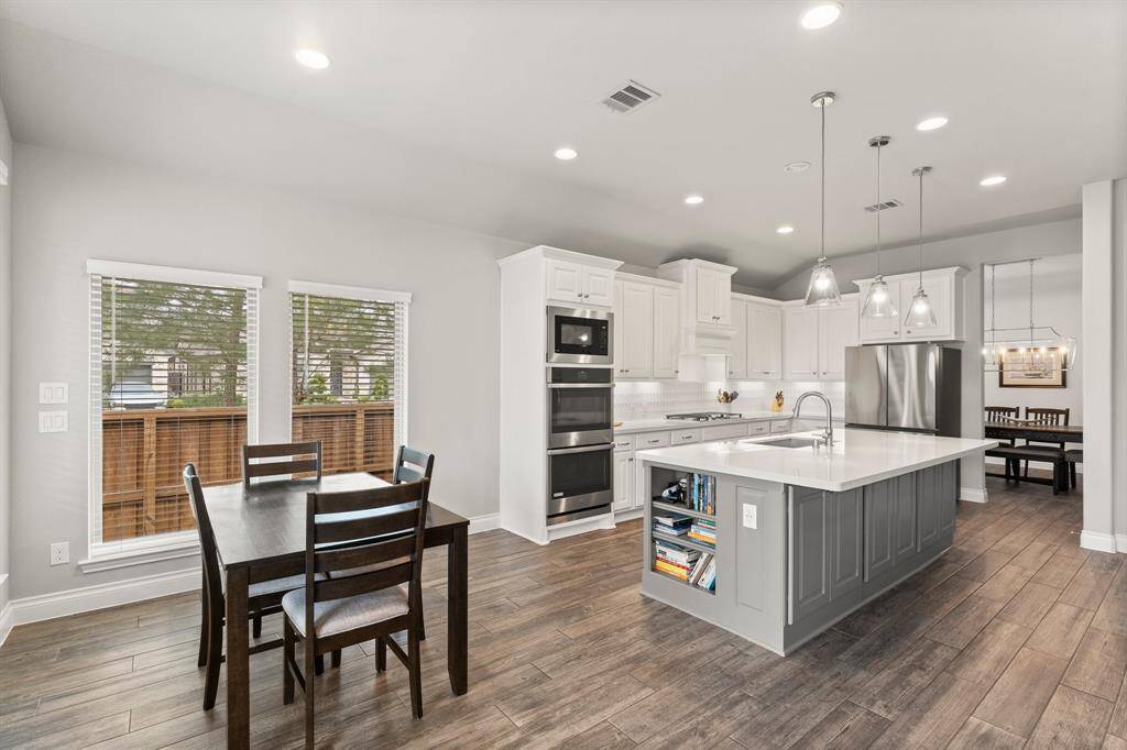 Sleek kitchen with built-in cookbook nook in the island.