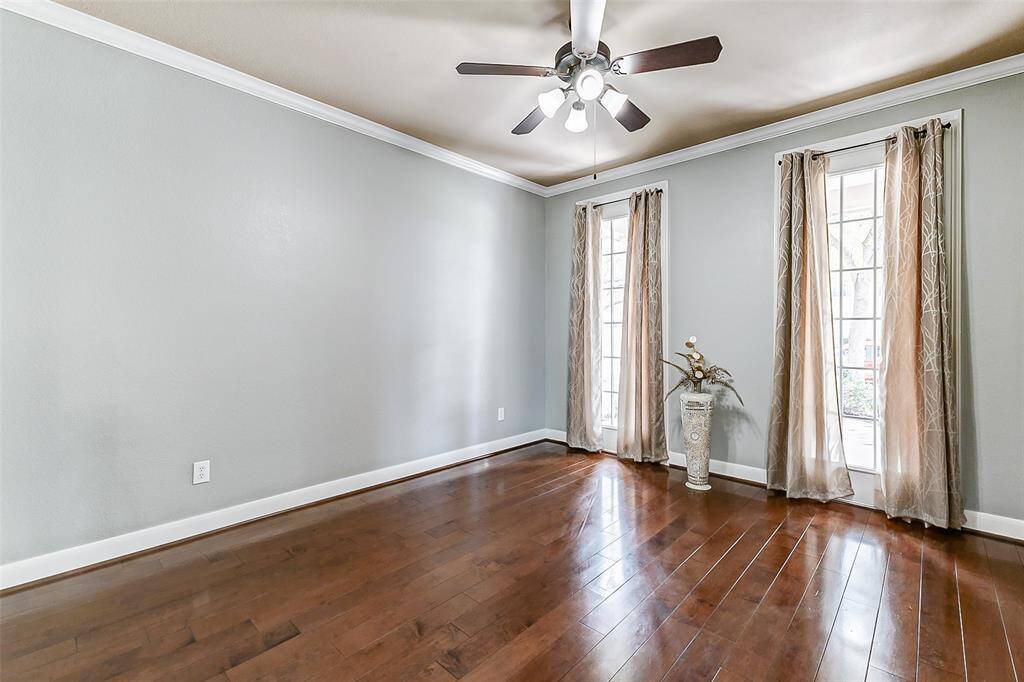With nearly floor-to-ceiling windows and rich hardwood flooring, this private workspace is bright, airy, and inspiring. A ceiling fan adds comfort, while French doors ensure quiet when needed.