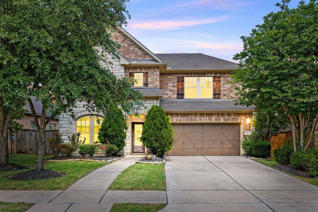 Welcome home to 4830 Ashley Hope Ln. located on a quiet street in Cinco Ranch Southwest and zoned to Katy ISD! This stunning home has lovely curb appeal, a well-manicured lawn, beautiful landscaping, stone/brick elevation, dark stained front door with glass detailing, covered front porch, traditional style, dark stained shutters, beautiful outdoor lanterns and a double wide driveway!