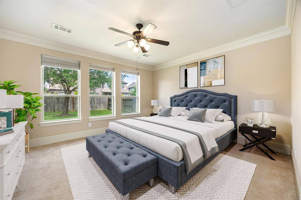What a wonderful place to come home to, this stunning primary suite greets you with gorgeous wood floors, a warm custom paint, high ceiling, crown molding, ceiling fan with lighting, lovely arched windows with blinds allowing in natural light brightening up this spacious primary bedroom, with extra space for a seating area. *Virtually Staged